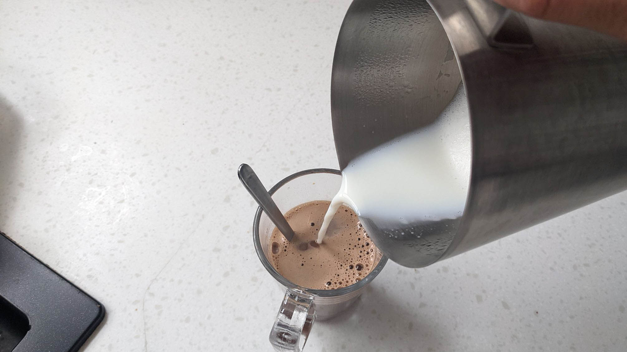 Pouring milk into coffee