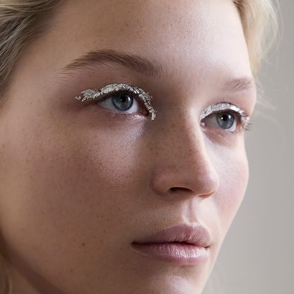 A model wearing silver metallic eye shadow