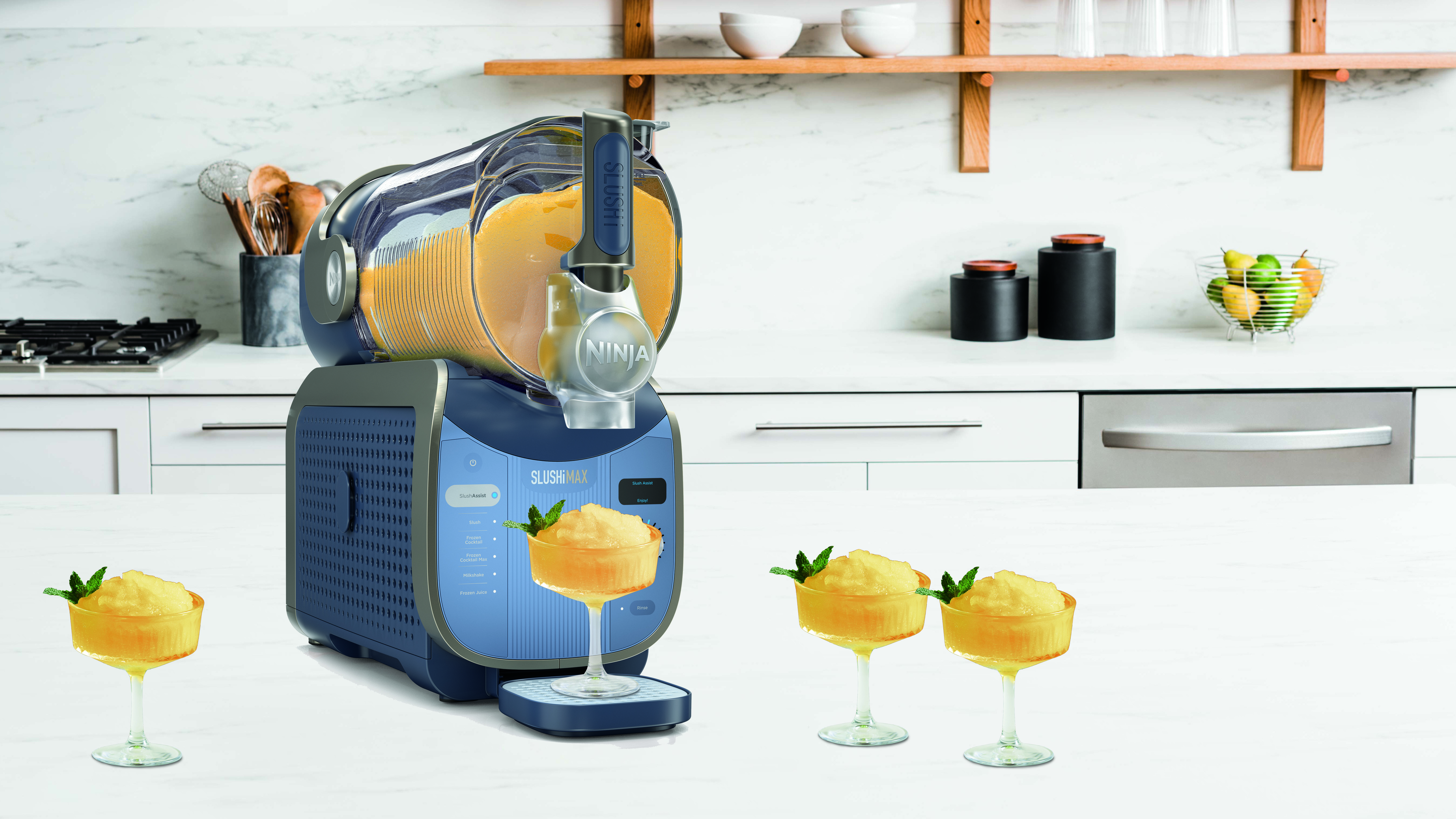 Ninja Slushi max in lifestyle setting with yellow drink and glasses
