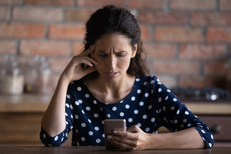 Unhappy woman use cellphone dissatisfied with gadget problem 