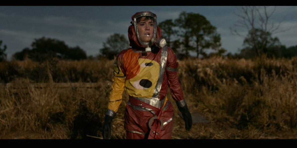 10 Cloverfield Lane Mary Elizabeth Winstead standing outside in her hazmat suit
