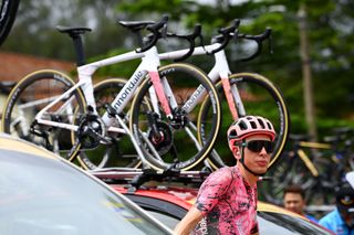 Hugh Carthy (EF Education-EasyPost) among the team cars at the start of stage 5 of the Tour de Langkawi in Kulim, Malaysia