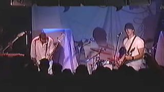 A screen shot of Queens Of The Stone Age playing at CBGBs in 1999