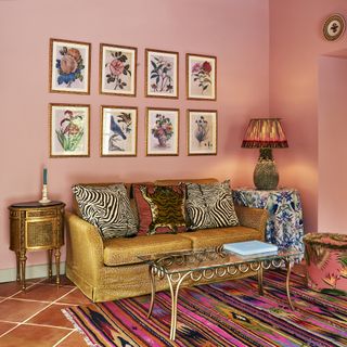 pink living room with gold sofa