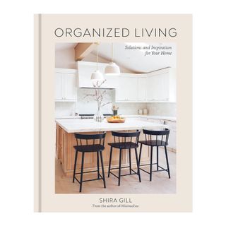 organized living by shira gill book cover with a bright light kitchen island and dark wood stools