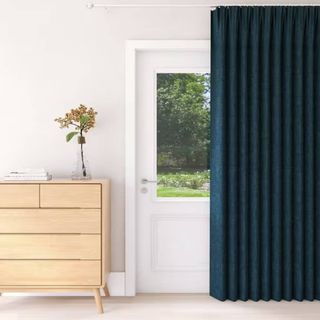 blue curtain hung in front of white door