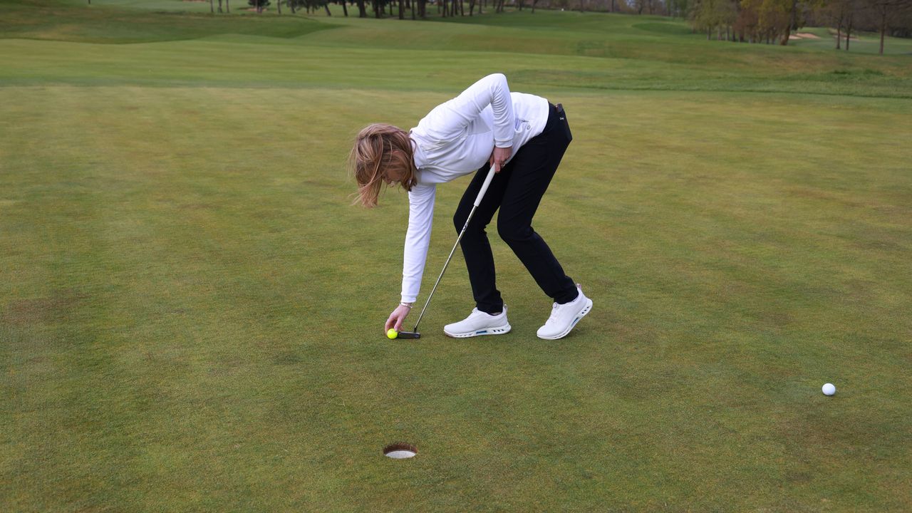 Player marking golf ball using toe of putter
