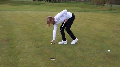 Player marking golf ball using toe of putter