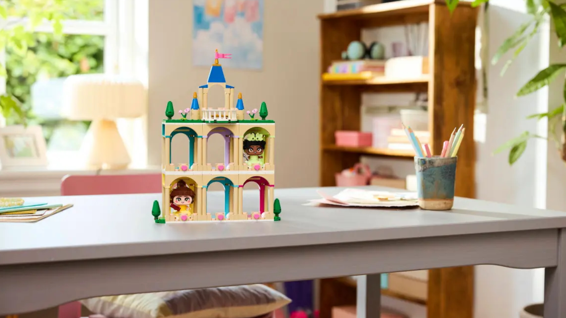 Mini Belle and Tiana's Lego Castle on a gray table
