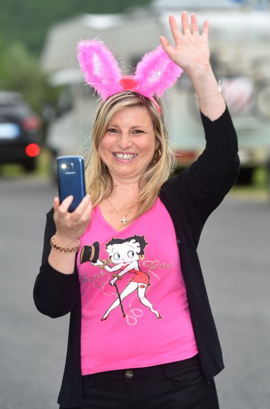A fan waves for the camera