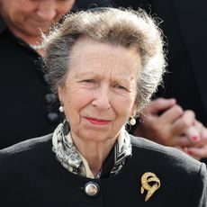 Princess Anne wearing a black coat and brooch