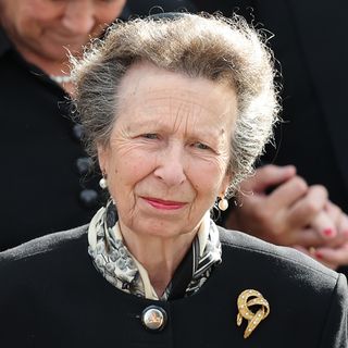 Princess Anne wearing a black coat and brooch