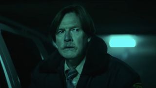 Donal Logue looking scared in the parking garage in Resident Evil Welcome To Raccoon City.