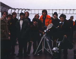 Members of the New York Amateur Observers' Society on the 86th floor Observation Deck of the Empire State Building on Dec. 13, 1974 (a Friday), with their instruments set up in hopes of observing a partial solar eclipse. Unfortunately, cloudy skies precluded a view of that day's promised celestial show. The author (me) is the 6th person from the left.