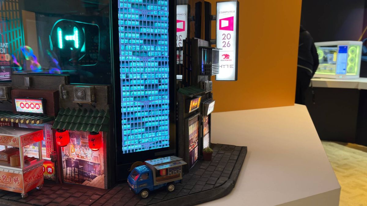 A tiny 3D printed Alex Honnold free solos up the side of a much bigger 3D printed recreation of the Taipei 101 building. The whole structure is built onto a Hyte Y70 Touch PC case.