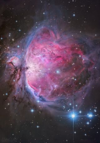 The Orion Nebula glows red and blue in this crisp, visible-light image by astrophotographer Miguel Claro.