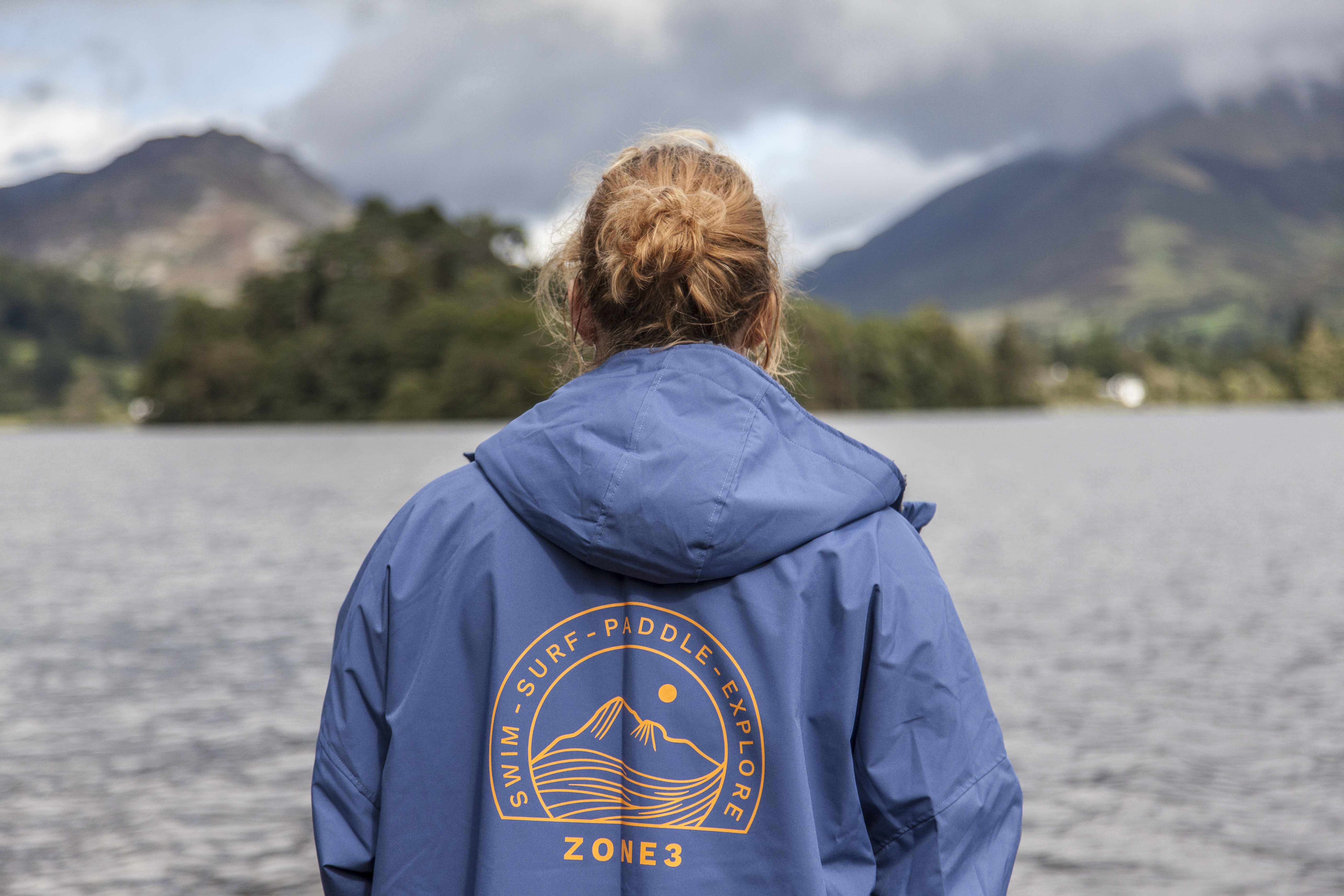 Woman standing in Grasmere lake wearing Zone3 thermotech changing robe