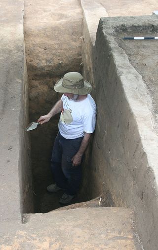 Archaeologist Robin Beck at the base of the Spanish moat, which measured is 5.5 feet (1.7 m) deep and 15 feet (4.5 m) across.