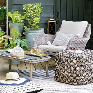 decking with potted plant hat table and chair