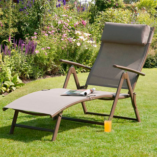 wooden resting chair with cushion in garden
