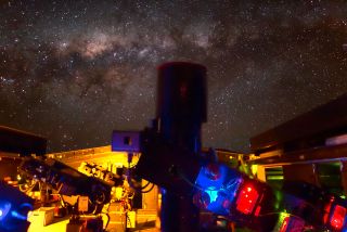 This night view shows the Next-Generation Transit Survey (NGTS) telescopes during testing. The central parts of the Milky Way appear in the background.