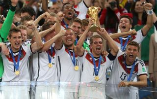 Germany’s Philipp Lahm lifts the World Cup and celebrates victory with team-mates after the 2014 World Cup final.