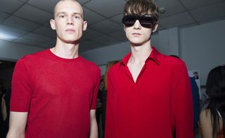 Head & shoulders shot of 2 male models wearing red clothing