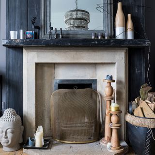fireplace set against wood panelling with candles and textural details