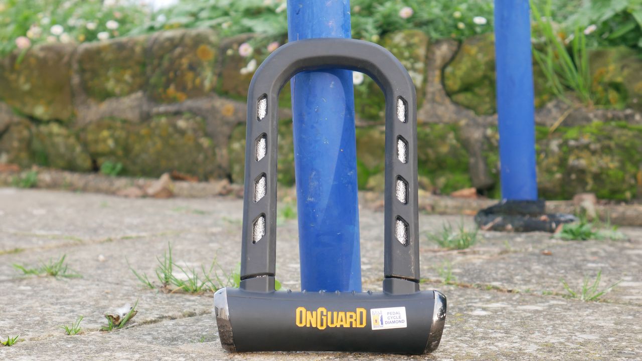 Our best overall angle grinder resistant lock the onguard rocksoild resting against a bike rack