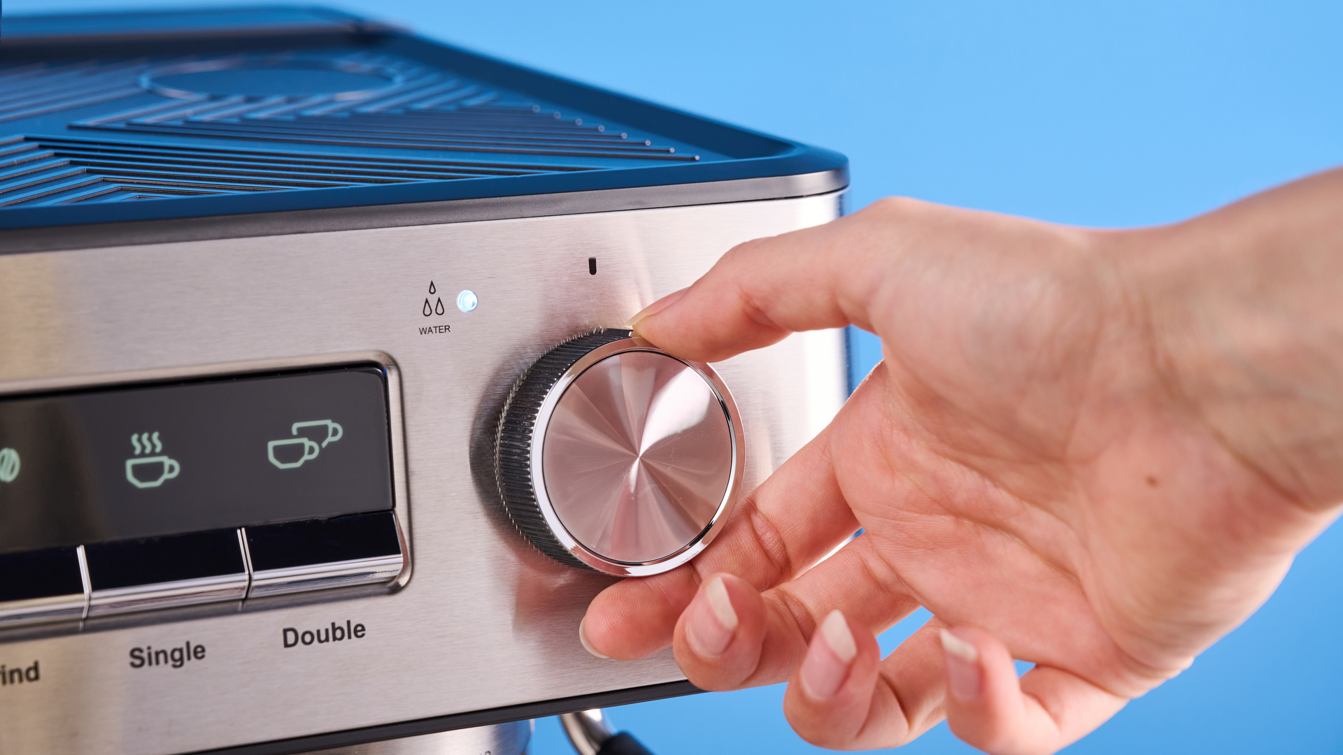 the gevi espresso machine with grinder showing its bean hopper, steam wand, and control screen with a silver dial and drip tray