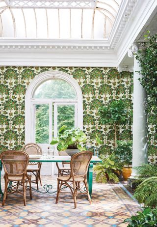 dining room with botanical leaf wallpaper
