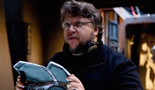 Pacific Rim Guillermo del Toro holding a breastplate of armor on set