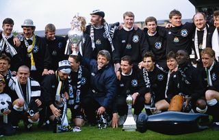 Newcastle United manager Kevin Keegan holds the League Division One trophy after the League Division One match against Leicester City at St James' Park on May 9, 1993 in Newcastle, England,( Back row left to right) Paul Bracewell, Terry McDermott (Assistant manager) Mark Robinson, Barry Venison (obscured) Brian Kilcline, Tommy Wright, Kevin Sheedy, Derek Fazackerley (coach) Derek Wright (physio) and Scott Sellars, (front row left to right) John Beresford, Lee Clark, David Kelly, Steve Howey (partially obscured) KK, Liam O' Brien, Gavin Peacock, Robert Lee, Andy Cole and Kevin Scot