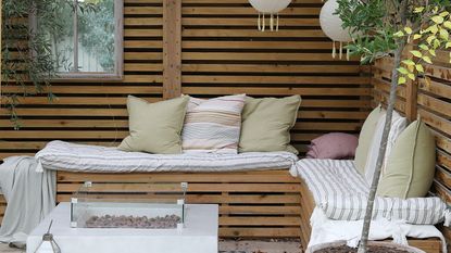 Outdoor dining area with wooden furniture and built in bench