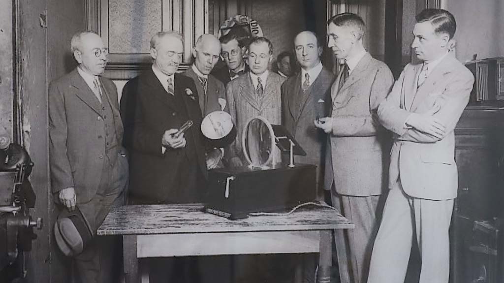 C. Frances Jenkins (second from left) explains the workings of his apparatus to those present at his June 13, 1925, television demonstration.