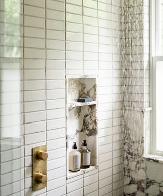 modern bathroom with tiled shower and marble niche