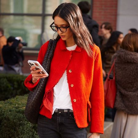 Woman in red sweater looking at her phone