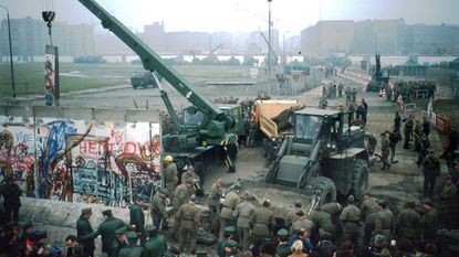 East Germans dismantling the Berlin Wall 