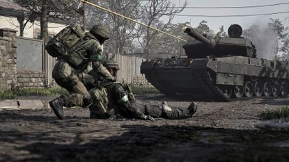 Wardogs soldier dragging a soldier in front of a tank