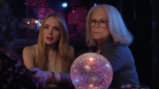 Jamie Lee Curtis and Lindsay Lohan talking next to a crystal ball in Freakier Friday