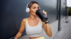 A woman drinking a protein shake after working out