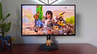 Alienware AW2725DF monitor with Overwatch 2 gameplay on screen and Pharah selected on character screen