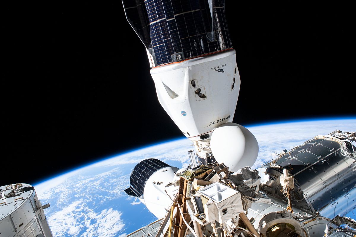 SpaceX&#039;s Crew Dragon Endeavour (bottom center) and a visiting uncrewed Cargo Dragon supply ship (foreground), are seen docked at the International Space Station&#039;s Harmony module in September 2021.