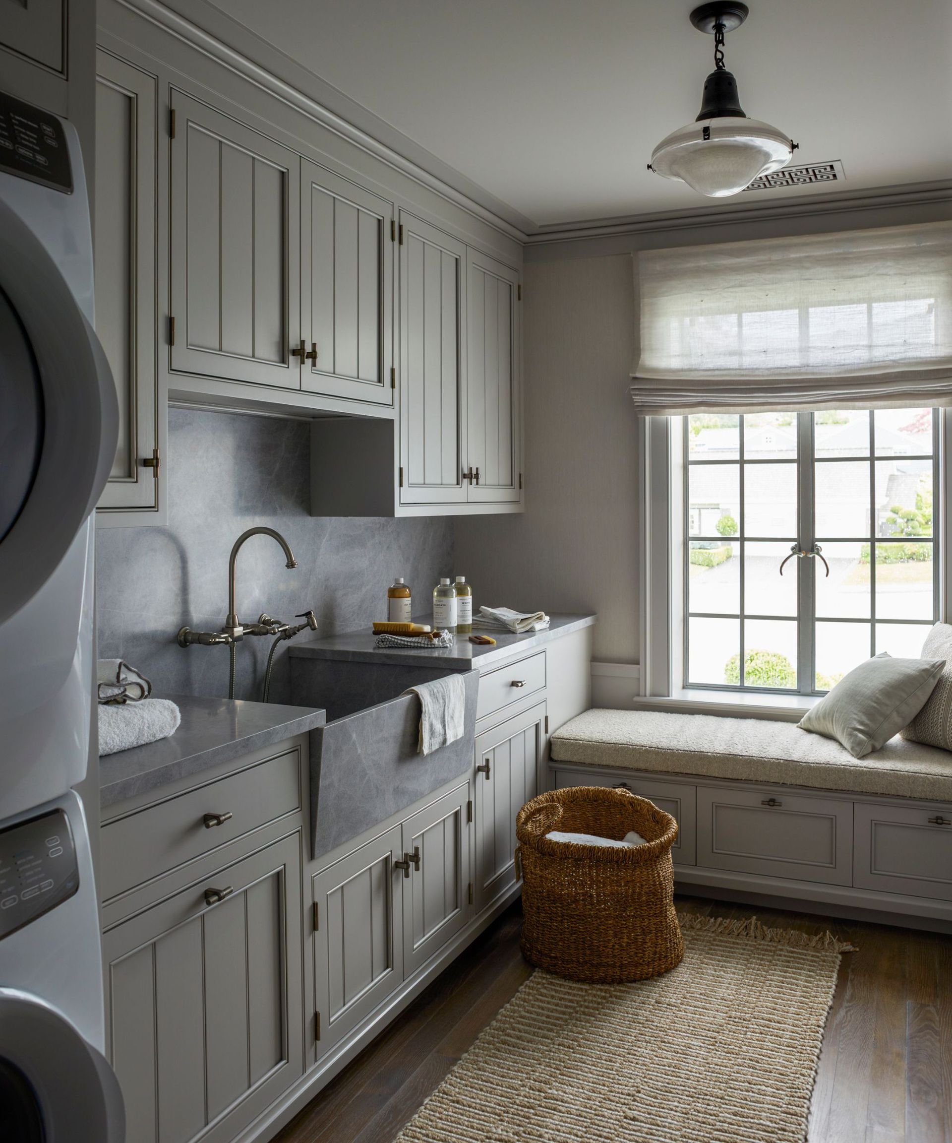 Laundry room with window seat