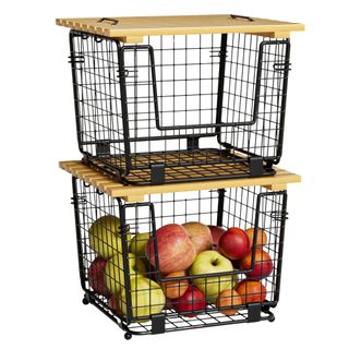 Two black wire pantry storage baskets filled with apples