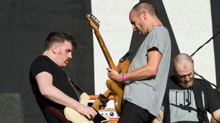 Niall Kennedy, Rory Friers and Johnny Adger of And So I Watch You From Afar perform onstage supporting Bring Me the Horizon during Belsonic 2016 at Titanic Slipways on June 17, 2016 in Belfast, Northern Ireland.