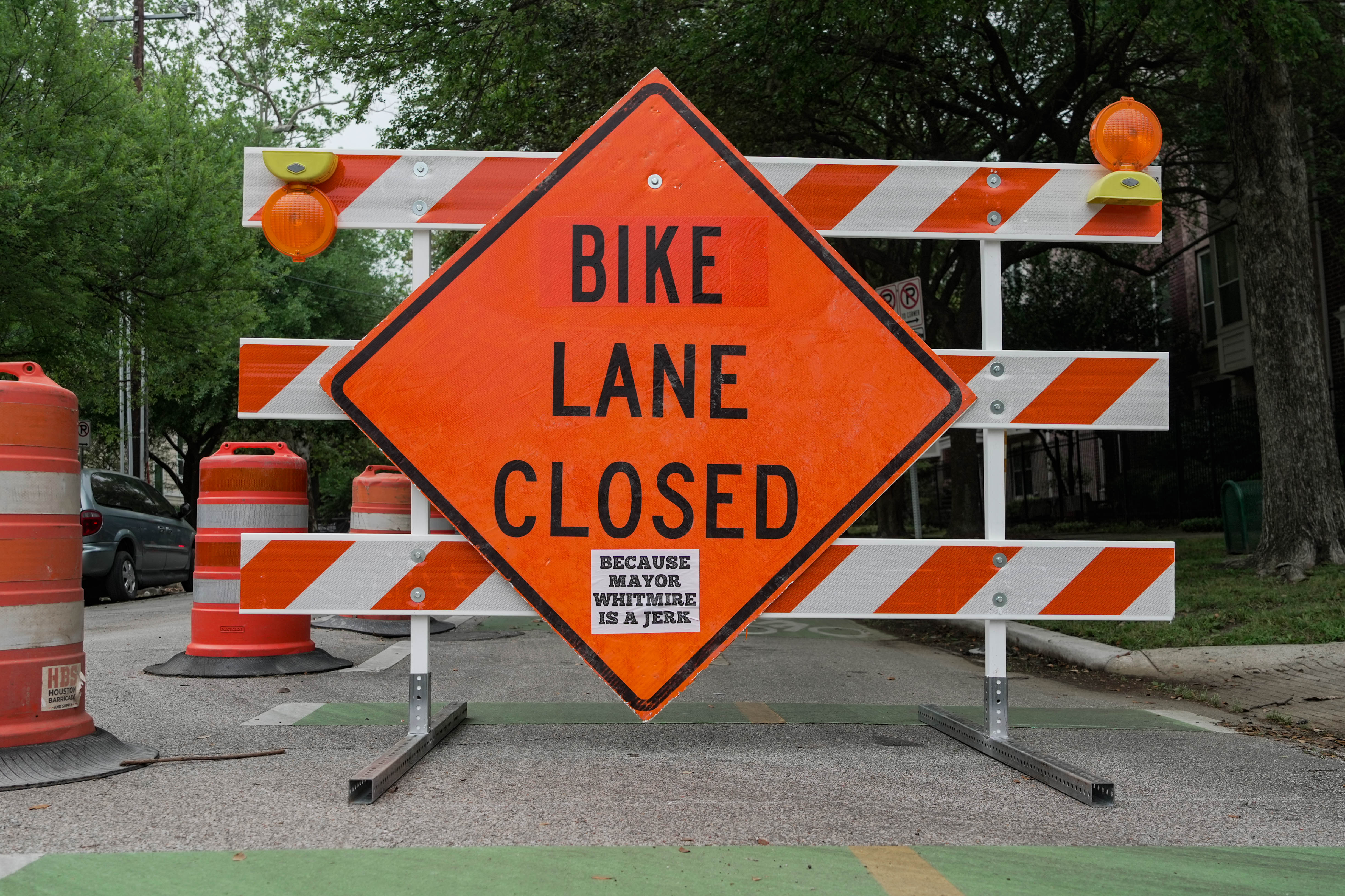 An orange sign saying &#039;bike lane closed&#039;