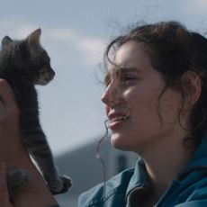 eva victor as agnes as she holds up a cat in sorry baby