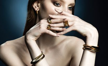 woman wearing gold jewellery by Ramona Albert