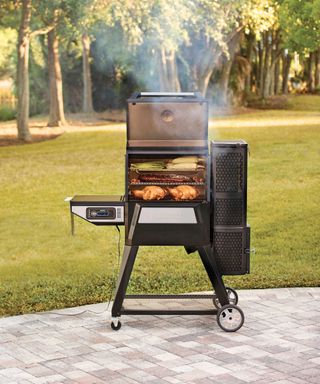 a charcoal grill and smoker with layers of grills for cooking